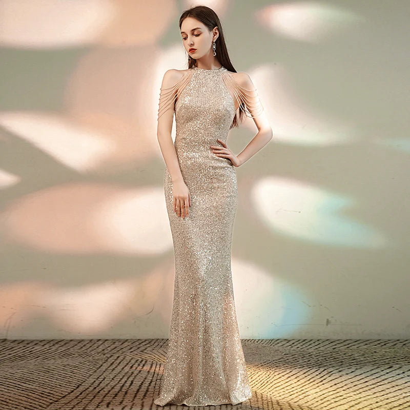 Woman wearing a sparkly evening gown against a softly lit background
