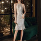 Woman in a silver sequin dress standing in a room with decorative lights.