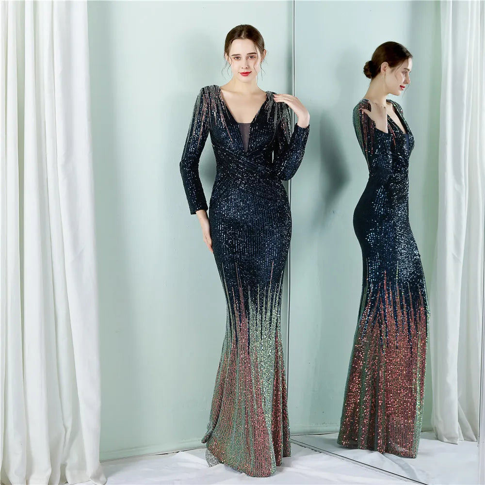 Woman wearing a long, elegant dress with a gradient effect in front of a white curtain.